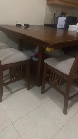 Wooden dining table with 8 cushioned stools - compact set