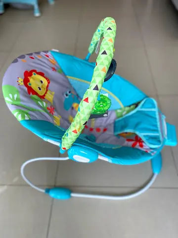 Blue baby bouncer rocker with toy bar - gently used