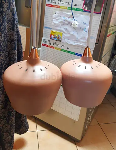 Pair of modern rose-gold pendant lights (two fixtures). Unused. AED. 290 Only. Free Delivery!