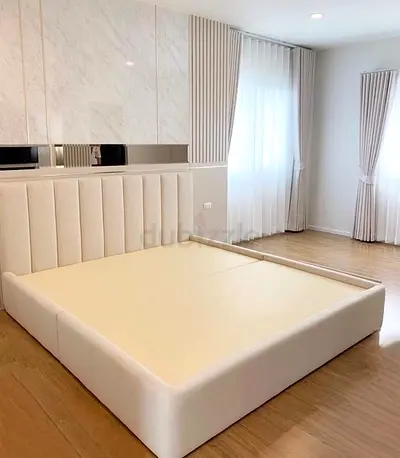 Cream upholstered platform bed frame with padded headboard - King size