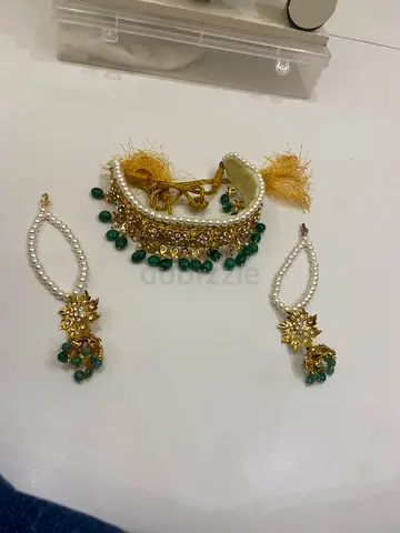 Traditional gold-tone choker with green beads and matching earrings