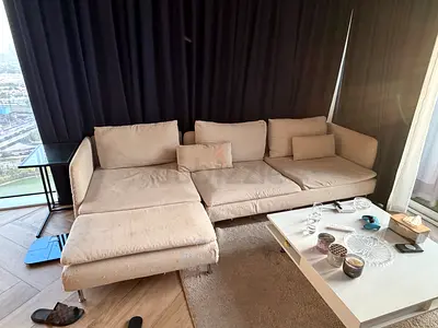 Light beige L-shaped fabric sofa with chaise