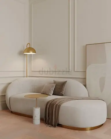 Modern curved cream sofa with gold trim - excellent condition