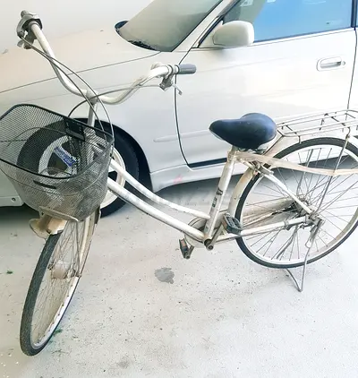 Classic White Cruiser Bicycle with Front Basket and Rear Rack