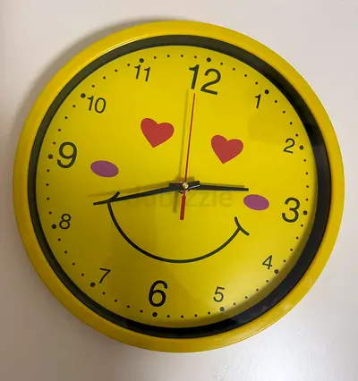 Yellow kids smiley face wall clock