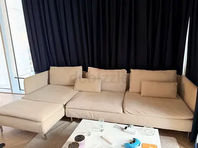 Light beige L-shaped fabric sofa with chaise