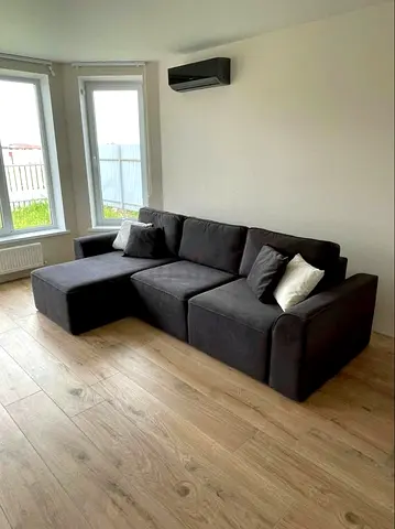 Dark grey L-shaped fabric sofa with chaise