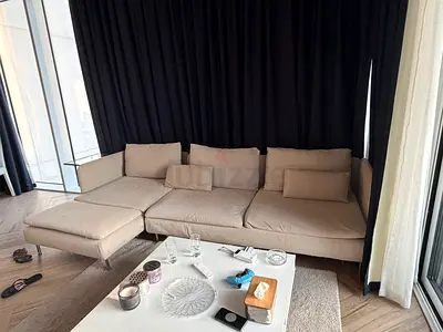 Light beige L-shaped fabric sofa with chaise