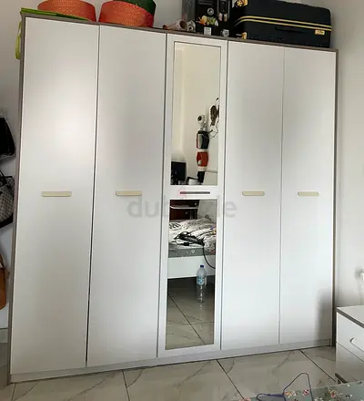 Queen bed with mattress and bedside table in furnished bedroom- 900
