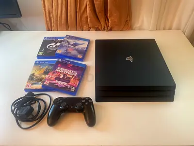 PlayStation 4 (Pro) with original DualShock, cables and 4 PS4 Games - perfect condition