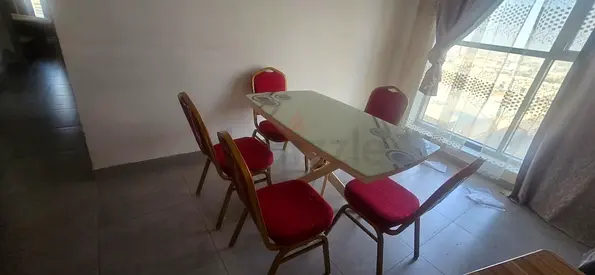 Wooden dining table with 5 red upholstered banquet chairs - good condition