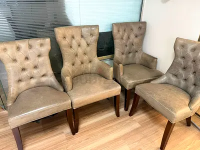 Set of 7 tufted leather dining chairs with wooden legs — good condition