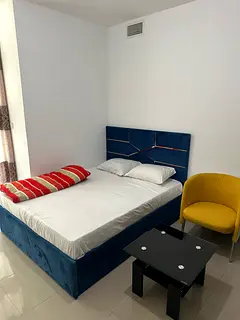 Master bedroom with private balcony available for rent at sport city.