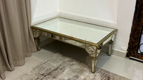 Low mirrored coffee table with glass top — used, good condition