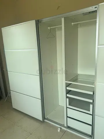 White sliding-door wardrobe with drawers and hanging rails - good condition