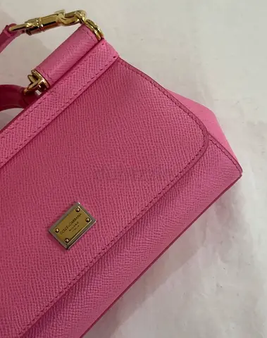 Pink structured leather top-handle bag with gold hardware
