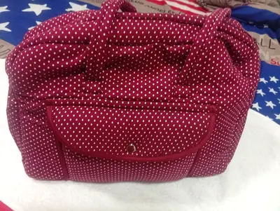 Maroon polka dot shoulder bag with babyshop baby changing mat