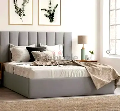 New Grey upholstered queen bed with padded headboard and mattress