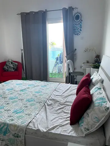 Queen bed with mattress and bedside table in furnished bedroom
