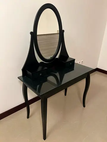Black wooden dressing table with oval mirror and glass top