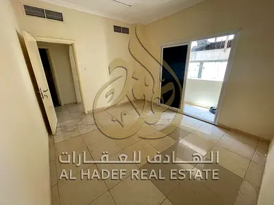One-bedroom apartment with a living room available for annual rent in Al Qasimiya. Features include a balcony with a view, a very spacious layout, and