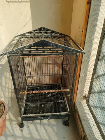 Metal bird cage on wheels — good condition
