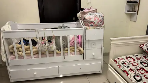 White convertible baby crib with attached changer and storage - good condition