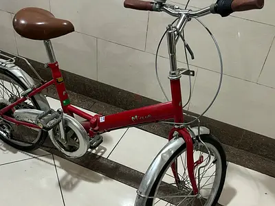 Red compact folding-style city bike — single-speed, good condition “negotiated”