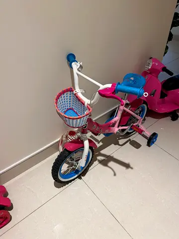 Girls pink  white kids bicycle with training wheels and basket - good condition