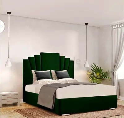 Green upholstered double bed with statement scalloped headboard