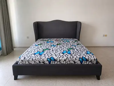 Queen-sized upholstered bed with wingback headboard - dark grey with mattress.