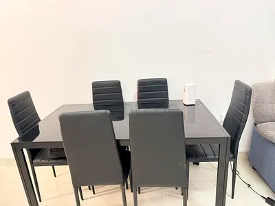 Modern black glass top dining table with 6 matching chairs