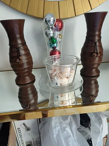 Pair of carved wooden candle holders with glass hurricane vase