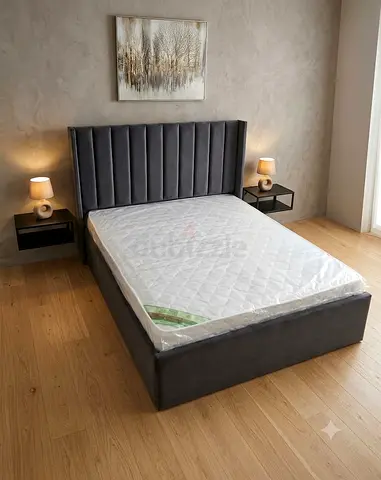 Grey upholstered double bed frame with headboard