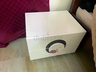 White bedside nightstand with floral drawer design