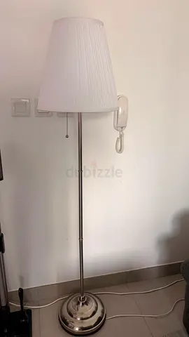 White floor lamp with pleated fabric shade and metal base