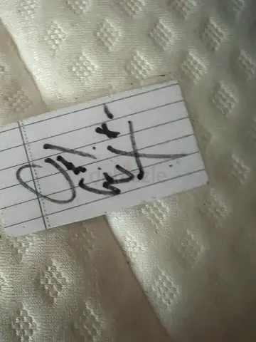 signed piece of paper by muggsy bouges laminated to be preserved