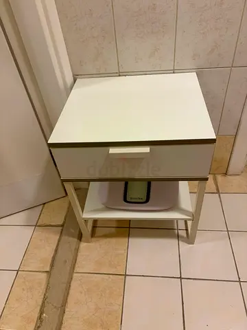 Simple white bedside table with drawer and open shelf