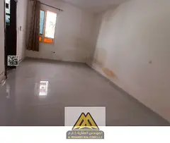 Annual studio in Al Rashidiya 3, ground floor, large space, semi-separated kitchen, near Amina Hospi
