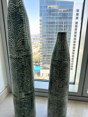 Pair of tall green patterned decorative floor vases