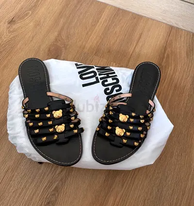 Black studded slide sandals with gold bear details - Moschino’s