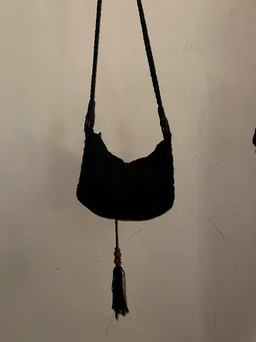 Handmade black woven shoulder bag with tassel