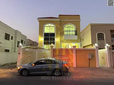 Villa for sale in Ajman – Al Rawda 2 area, prime location on a corner lot (street and alley), price includes electricity, water, and air conditioning,
