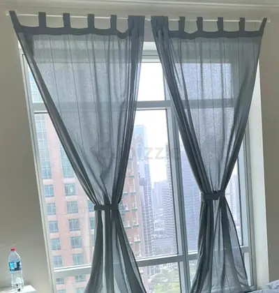 Light-filtering blue tab-top curtains - pair