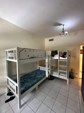 White wooden bunk bed with built-in shelving - good condition