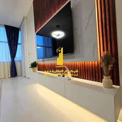First tenant, luxurious and elegant two-bedroom apartment with a fully furnished living room, available for monthly rent in Ajman Corniche.