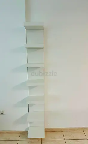 Slim white wall-mounted corner shelf unit - 6 tiers