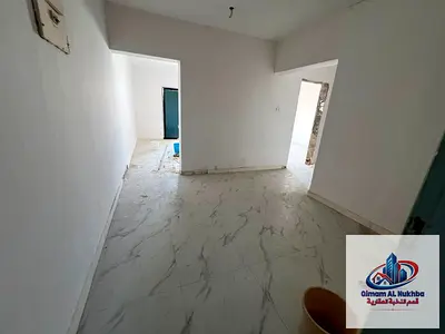 **Official shared accommodation for bachelors** in **Al Majaz 2, Sharjah**, inside a **3-bedroom apartment with a spacious living room**, featuring **