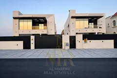 Two-story villa with a rooftop terrace, freehold, in one of Ajman's most prestigious areas, on a mai