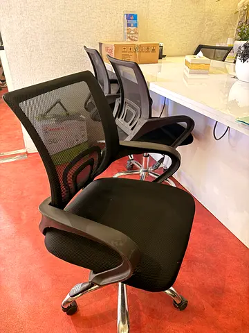 7 Black ergonomic mesh office chair with armrests and caster wheels
